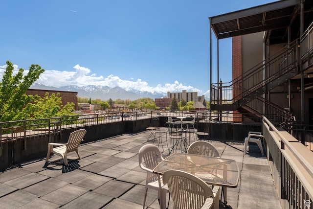 228 E 500 S Unit 301, Salt Lake City, UT 84111 - view of patio featuring stairway, outdoor dining space, and a mountain view