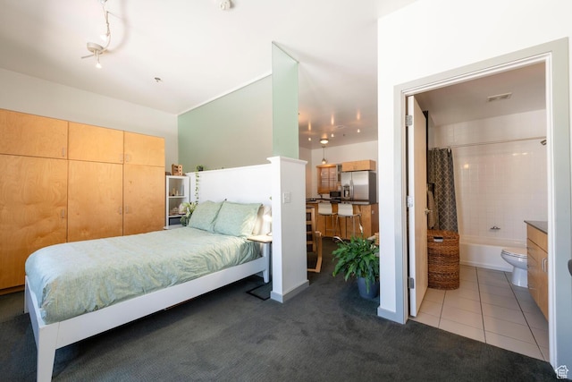 228 E 500 S Unit 301, Salt Lake City, UT 84111 - bedroom with carpet, ensuite bath, stainless steel fridge, and tile patterned flooring