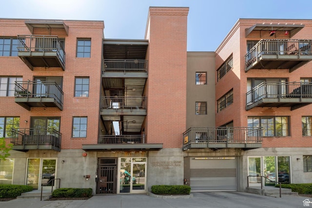 228 E 500 S Unit 301, Salt Lake City, UT 84111 - view of building exterior featuring concrete driveway and a garage