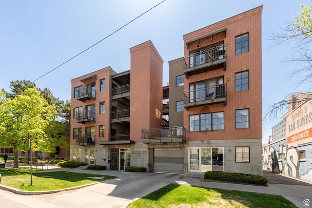 228 E 500 S Unit 301, Salt Lake City, UT 84111 - view of property featuring concrete driveway and an attached garage