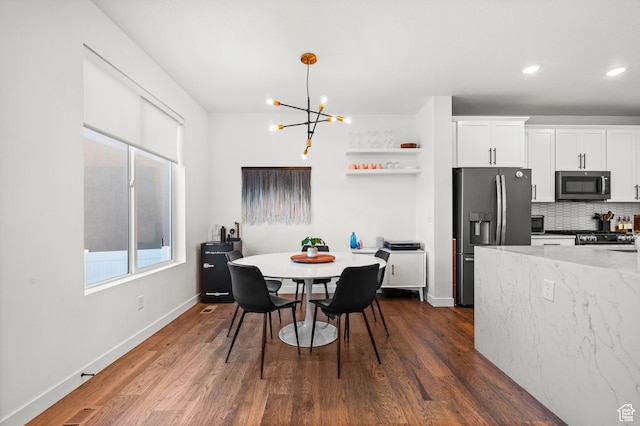 kitchen featuring open shelves, a chandelier, dark wood-style flooring, white cabinets, and appliances with stainless steel finishes