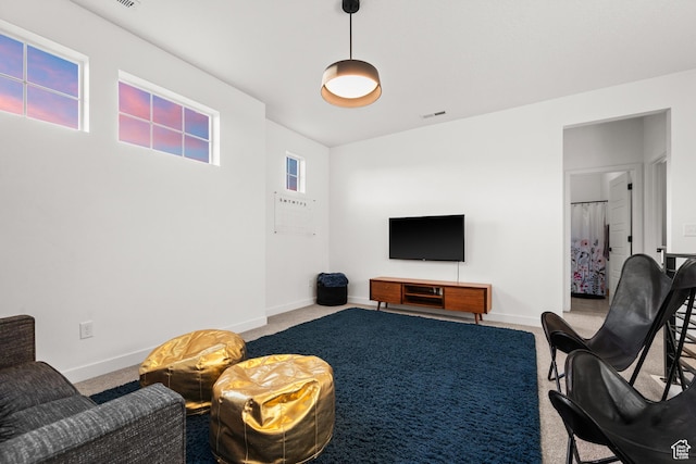carpeted living room with visible vents and baseboards