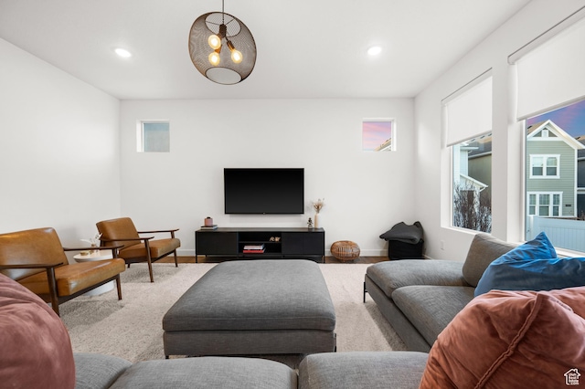 living room featuring baseboards, recessed lighting, and plenty of natural light