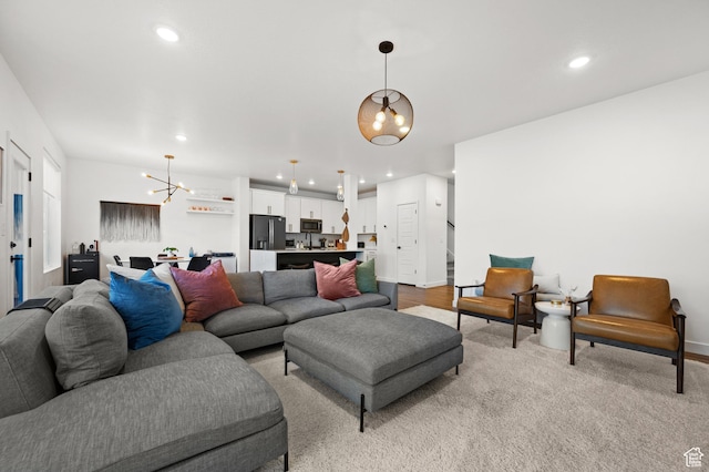 living room with baseboards, a chandelier, and recessed lighting