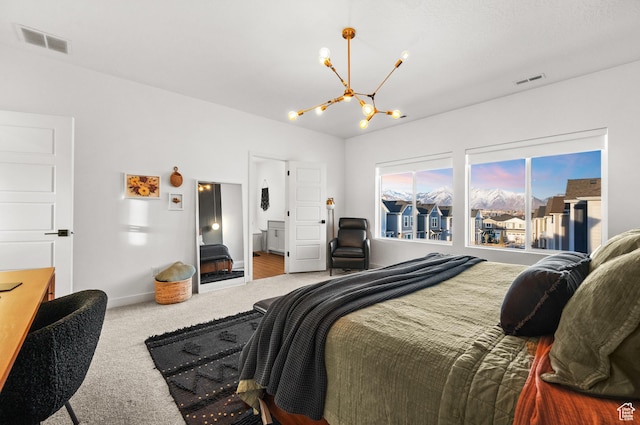 carpeted bedroom featuring a notable chandelier, baseboards, and visible vents