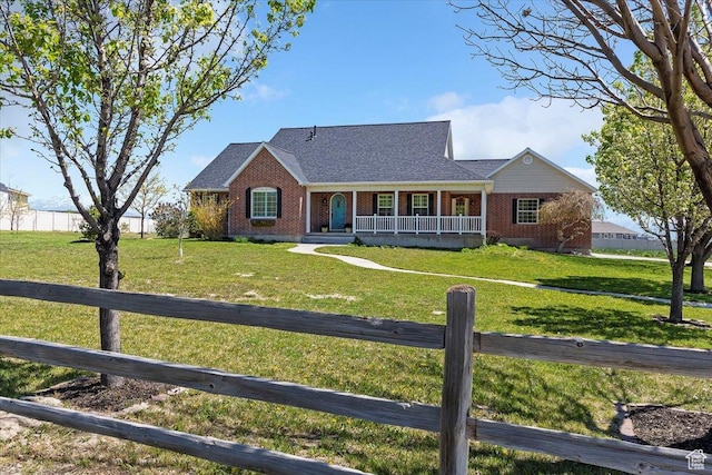 9138 N Deerfield Cir, Eagle Mountain, UT 84005 - ranch-style house with covered porch, a shingled roof, a front yard, brick siding, and fence private yard