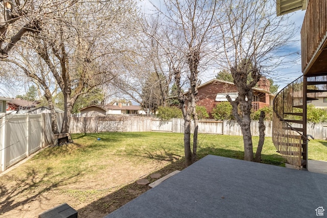 view of yard featuring a patio, stairway, and a fenced backyard