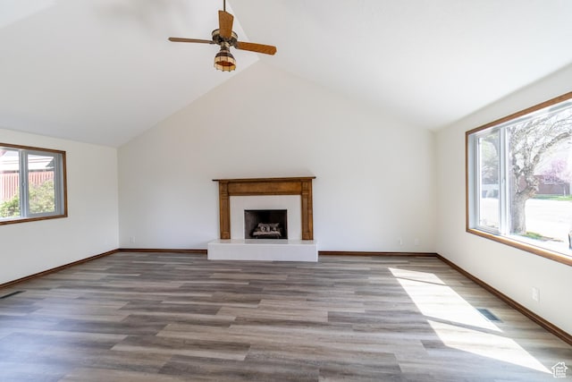 unfurnished living room with vaulted ceiling, ceiling fan, visible vents, and wood finished floors