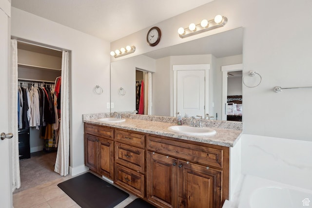 667 S Falkirk Rd Unit 24, Heber City, UT 84032 - bathroom featuring tile patterned floors, double vanity, a sink, and a walk in closet