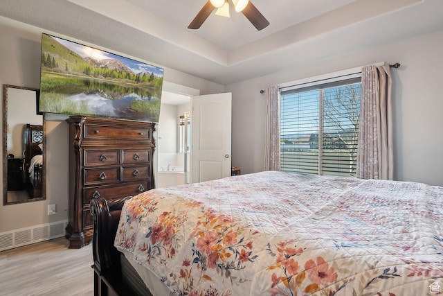 667 S Falkirk Rd Unit 24, Heber City, UT 84032 - bedroom with a tray ceiling, ensuite bathroom, ceiling fan, visible vents, and light wood-style floors