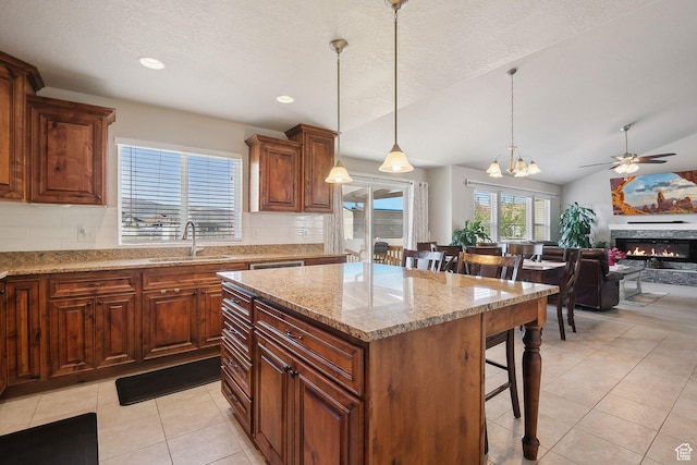 667 S Falkirk Rd Unit 24, Heber City, UT 84032 - kitchen featuring light tile patterned floors, a sink, a kitchen breakfast bar, decorative backsplash, and vaulted ceiling