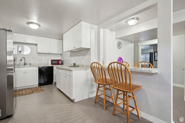 667 S Falkirk Rd Unit 24, Heber City, UT 84032 - kitchen with freestanding refrigerator, black dishwasher, white cabinets, and a sink