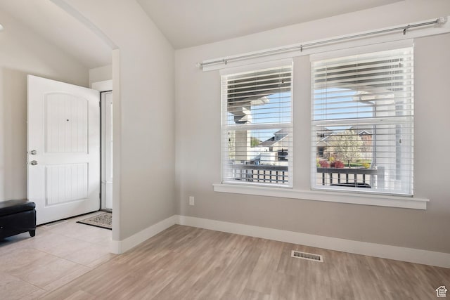 667 S Falkirk Rd Unit 24, Heber City, UT 84032 - empty room featuring vaulted ceiling, baseboards, visible vents, wood finished floors, and arched walkways