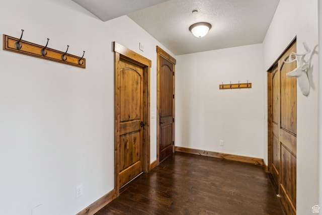 9855 N N Vista Dr Unit 104, Heber City, UT 84032 - corridor featuring a textured ceiling, dark wood-type flooring, and baseboards