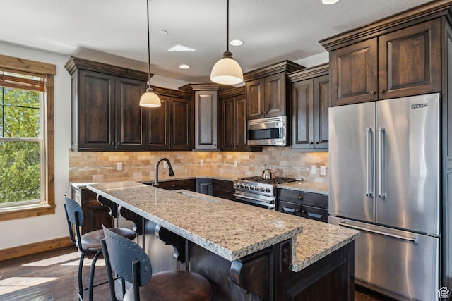 9855 N N Vista Dr Unit 104, Heber City, UT 84032 - kitchen featuring dark brown cabinetry, light stone countertops, high quality appliances, and dark wood-type flooring