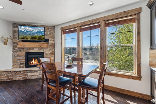 9855 N N Vista Dr Unit 104, Heber City, UT 84032 - dining space with dark wood-style flooring, a stone fireplace, recessed lighting, and a wealth of natural light