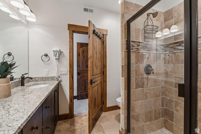 9855 N N Vista Dr Unit 104, Heber City, UT 84032 - bathroom featuring toilet, vanity, visible vents, a shower stall, and baseboards