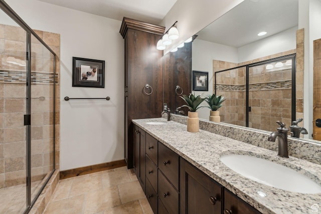9855 N N Vista Dr Unit 104, Heber City, UT 84032 - full bathroom featuring a stall shower, baseboards, double vanity, and a sink