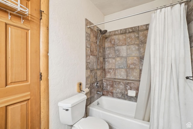bathroom with toilet, shower / bathtub combination with curtain, and a textured wall