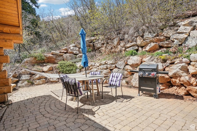 view of patio with area for grilling and outdoor dining space