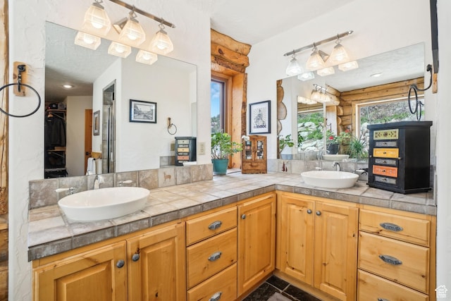 bathroom featuring a sink and double vanity