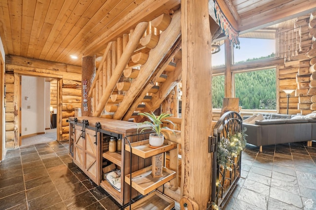 interior space with rustic walls, wood ceiling, and stone tile flooring