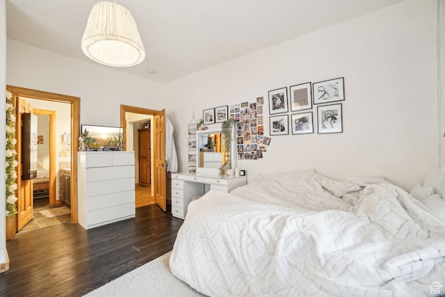 bedroom with dark wood finished floors and ensuite bath