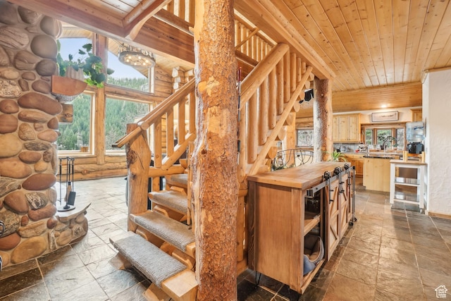 staircase with stone tile floors, wood ceiling, and rustic walls