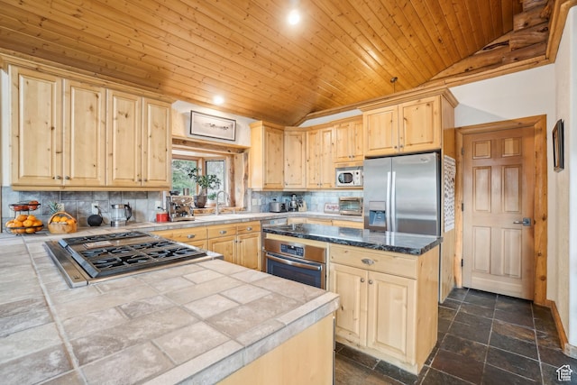 kitchen featuring lofted ceiling, light brown cabinets, wood ceiling, decorative backsplash, and appliances with stainless steel finishes