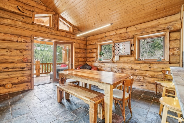 dining room with stone tile floors, wood ceiling, high vaulted ceiling, and rustic walls