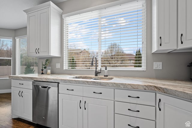kitchen with dark wood finished floors, dishwasher, white cabinetry, and a sink