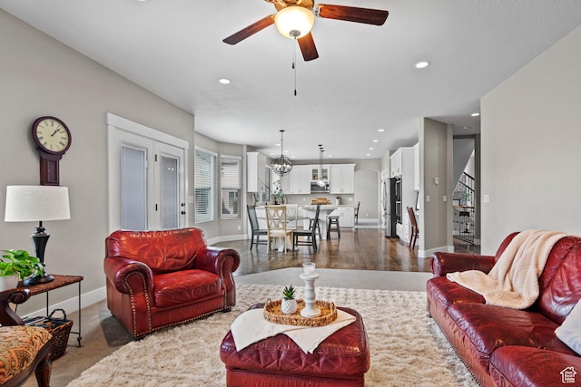 living area featuring baseboards, stairs, recessed lighting, and ceiling fan
