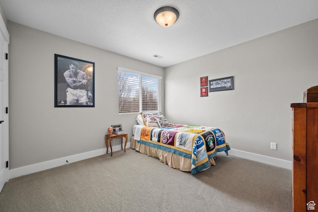 bedroom with a textured ceiling, carpet, baseboards, and visible vents