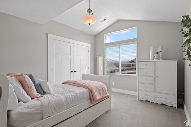 bedroom featuring a closet, baseboards, visible vents, vaulted ceiling, and light carpet