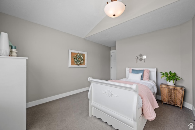 carpeted bedroom featuring baseboards and lofted ceiling