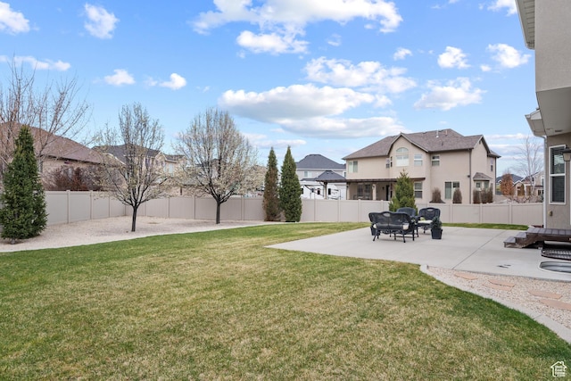 view of yard featuring a patio, a residential view, and a fenced backyard