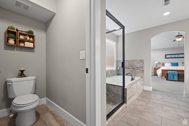 full bath with ceiling fan, toilet, a garden tub, and visible vents