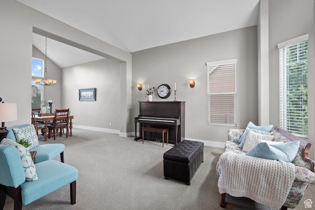 carpeted living area featuring an inviting chandelier, lofted ceiling, and baseboards