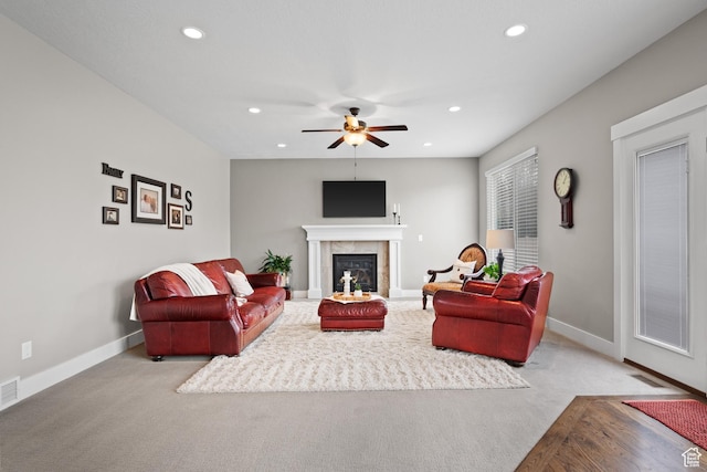 living room with recessed lighting, carpet, baseboards, a tiled fireplace, and ceiling fan