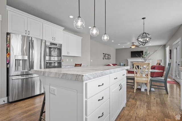 kitchen featuring recessed lighting, ceiling fan with notable chandelier, dark wood-style floors, and appliances with stainless steel finishes