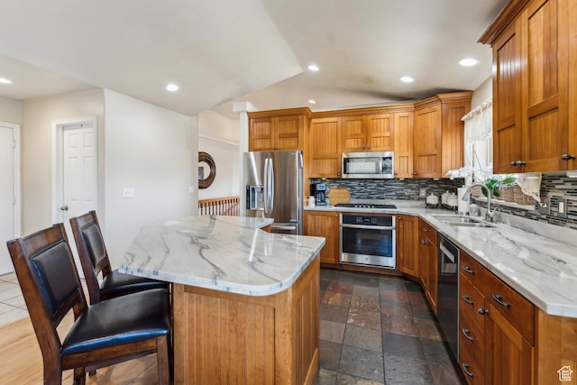 kitchen with a sink, stainless steel appliances, decorative backsplash, and recessed lighting