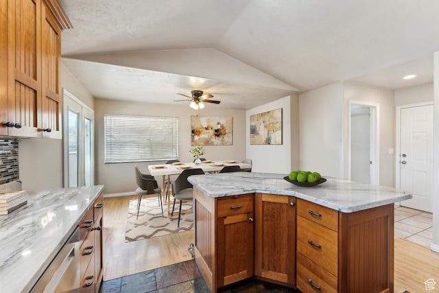 801 E 380 N Unit 57, Heber City, UT 84032 - kitchen featuring a ceiling fan, lofted ceiling, light stone countertops, a kitchen island, and wood finished floors