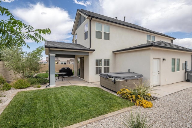 5740 Cardinal Wing Dr Unit 17, St George, UT 84790 - rear view of house with a lawn, a hot tub, a patio, stucco siding, and a fenced backyard