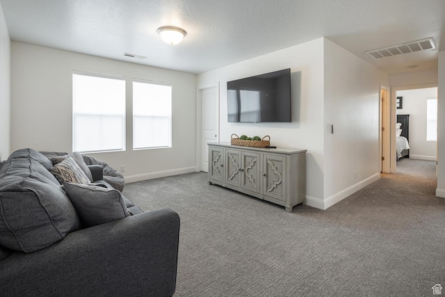 5740 Cardinal Wing Dr Unit 17, St George, UT 84790 - living room featuring light colored carpet, baseboards, and visible vents