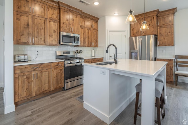 5740 Cardinal Wing Dr Unit 17, St George, UT 84790 - kitchen featuring brown cabinetry, stainless steel appliances, and a sink