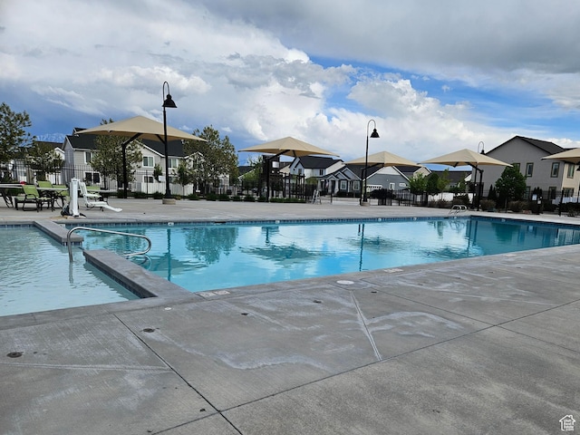 452 S Highpoint Dr, Saratoga Springs, UT 84045 - pool with fence, a patio area, and a residential view