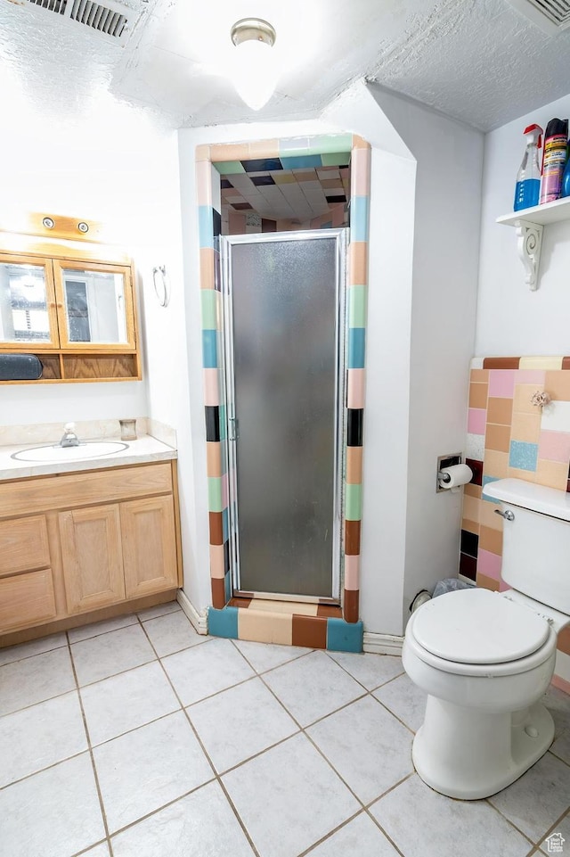 full bathroom with toilet, visible vents, a shower stall, tile patterned floors, and vanity
