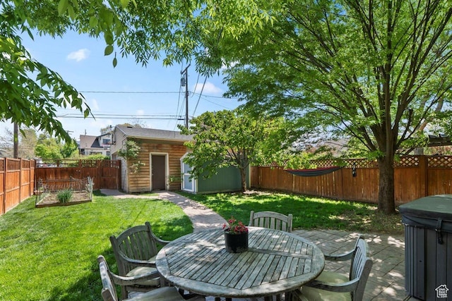 1159 S Windsor St, Salt Lake City, UT 84105 - view of yard featuring an outbuilding, outdoor dining area, a fenced backyard, and a patio