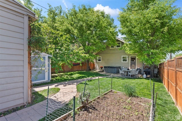 1159 S Windsor St, Salt Lake City, UT 84105 - view of yard featuring a hot tub, an outdoor structure, a storage unit, a fenced backyard, and a garden