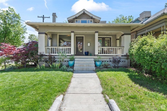 1159 S Windsor St, Salt Lake City, UT 84105 - view of front of property with covered porch, brick siding, a chimney, and a front yard